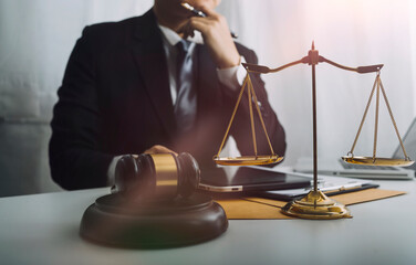 justice and law concept.Male judge in a courtroom on wooden table and Counselor or Male lawyer...