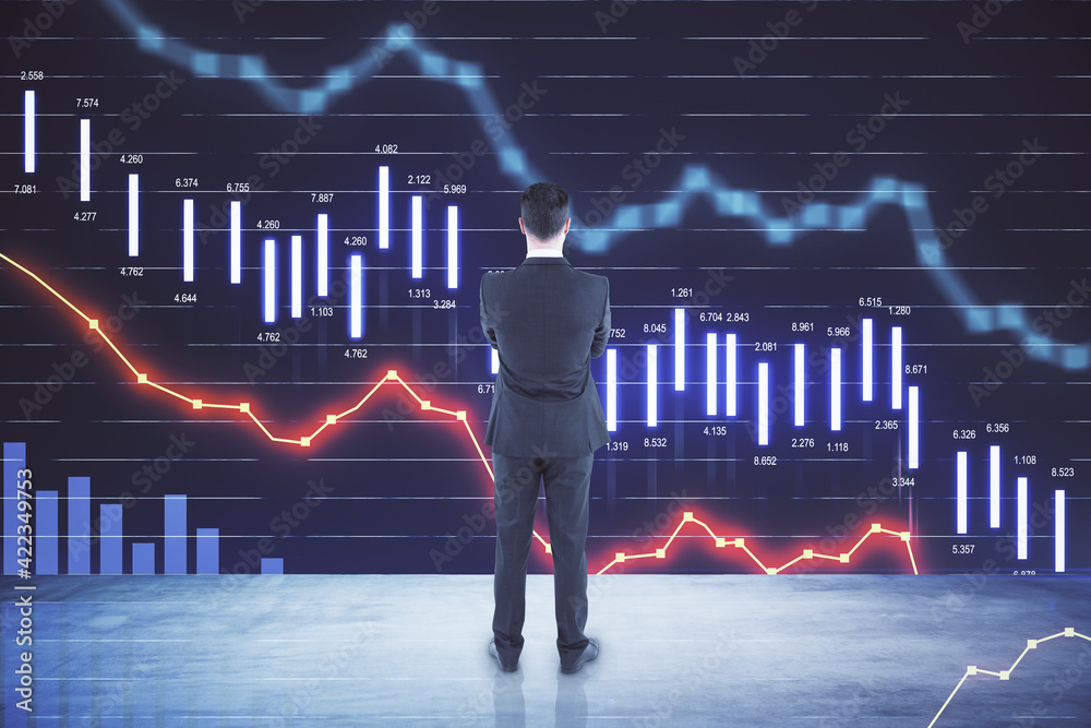 Poster crisis concept with businessman looking at big digital screen with falling financial chart graphs an
