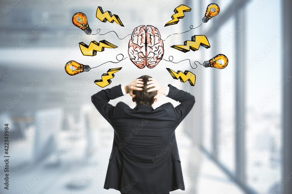 Poster idea and brainstorm concept with businessman in in front of handwritten sign of human brain, yellow 