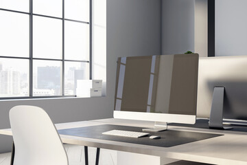 Black modern computer monitor on wooden worktable with white chair in sunny office with big window and city view