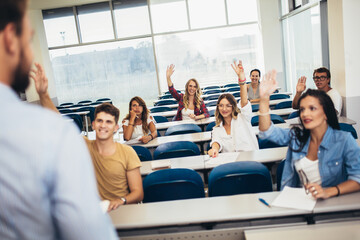 Young students listening to professor in the classroom on college