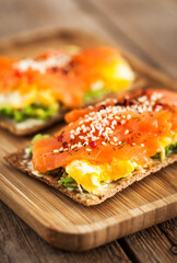 Salted salmon, scrambled eggs, avocado and cream cheese rye crisp toast