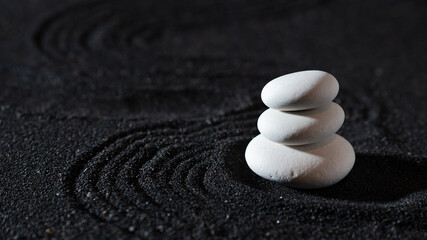 rock garden, white pebbles on black sand, wavy patterns.