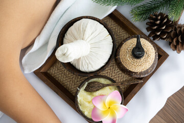 View of Spa Treatment  Set  with Massage oil , Sea Salt and  Herbal Compress Ball on Spa Bed