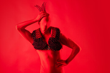 crazy fashion, a man in a red leotard on a red background,