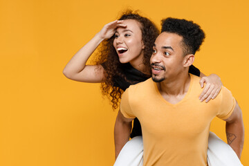 Young couple two friends together family african man woman 20s in black t-shirt giving piggyback...