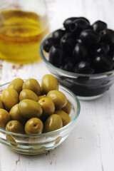 Black and green olives in glass bowls