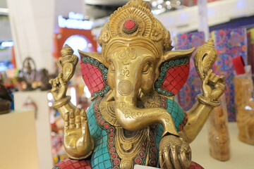 Ganesha is a bronze sculpture of a four-armed Indian God with an elephant's head.