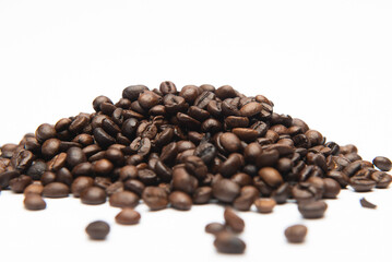dark roasted coffee beans on a white background