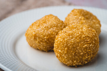 Pinoy Snack or Merienda – Buchi is a type of Chinese fried pastry made from glutinous rice flour, a sweet filling, and sesame seed coating (close up)