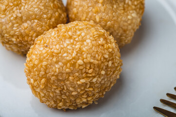Pinoy Snack or Merienda – Buchi is a type of Chinese fried pastry made from glutinous rice flour, a sweet filling, and sesame seed coating  (close up)