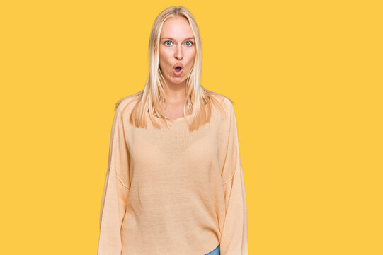 Young blonde girl wearing casual clothes afraid and shocked with surprise expression, fear and excited face.