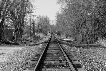 Train track disappearing into the horizon of rural America. Either a path out of town or a road to nowhere.