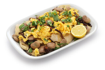 iraqi breakfast; boiled dried broad beans and scrambled eggs over pieces of flatbread ( bagila bil...