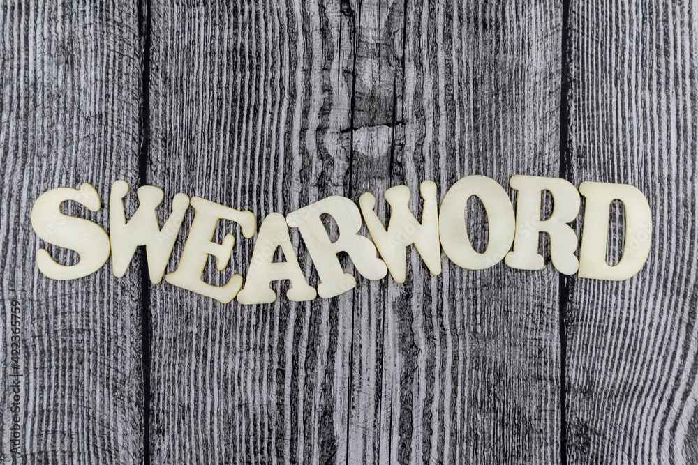 Fototapete swearword - concept design template on rustic wooden background with wavy line of alphabet letters a
