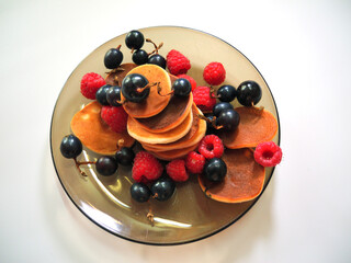 Small pancakes with fresh fruits and berries