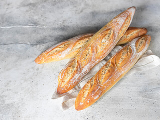 Fresh baguette on a wooden table on concrete background.Organic bread fresh. Homemade sourdough...