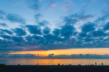 Fototapeta na wymiar Golden sunset over the Black Sea at Batumi beach