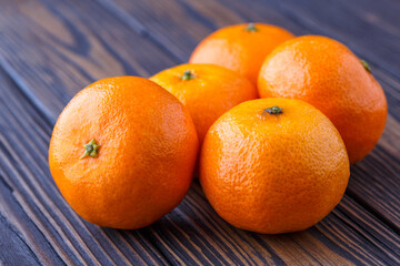 Mandarine orange or tangerine on wooden board