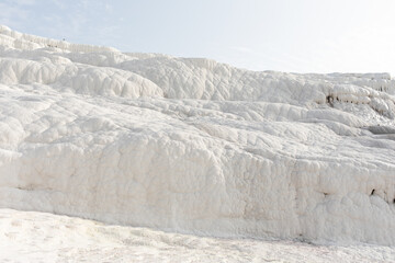 White texture cloudy calcium surface of Pamukkale mineral mountain in Turkey.