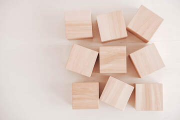 Wooden cubes from natural wood on a white background. Top view. Copy, empty space for text