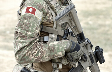 Soldier with assault rifle and flag of Tunisia on military uniform. Collage.
