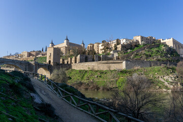 Fototapeta na wymiar the historic Spanish city of Toledo on the Tagus River with the Roman Bridge in the foreground