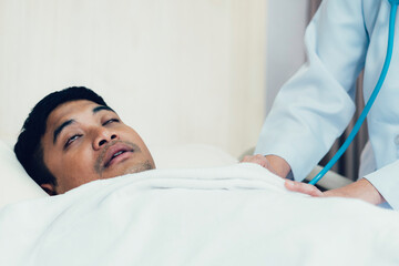 Fototapeta premium Sick Asian man sleeping in bed at hospital ward. concept for medical and healthcare