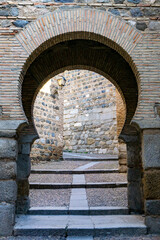 Fototapeta na wymiar Arabic horseshoe arch entrance through the old city wall in Toledo