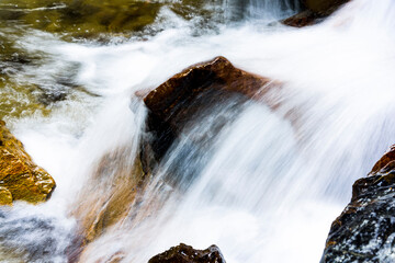 Fototapeta premium The stones under the waterfall, close-up waterfall as background.