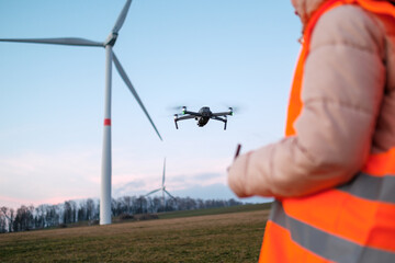Obraz na płótnie Canvas Technician engineer controls wind turbines using a drone. Production of green energy. Generation of power energy.