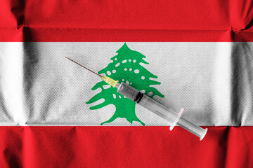 Concept of the ongoing efforts by Lebanon to deliver and distribute COVID-19 Vaccine with a syringe...