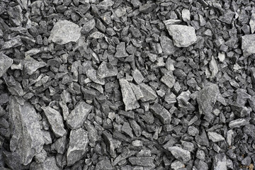 Gravel texture. Pebble stone background. Light grey closeup small rocks. Top view of ground gravel road.