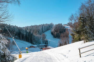 Winter sports slopes at the ski lift carousel Winterberg. Sledding slope and ski slopes between...