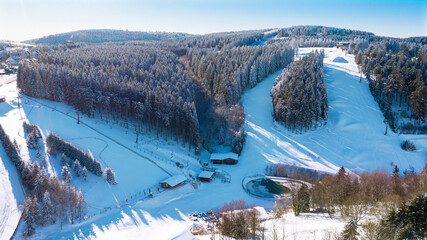 Air view on the winter sports slopes at the ski lift carousel Winterberg. Sledding slope and ski...