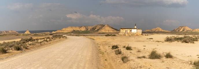 panorama of a lonesome hunting cabin in wild and secluded desert grasslands