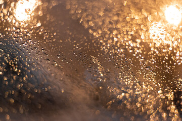 Blurred background with raindrops and lights.