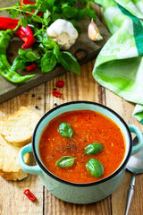 The concept of healthy and diet food, vegetarian dish. Tomato soup or gazpacho soup with croutons on a wooden rustic table.