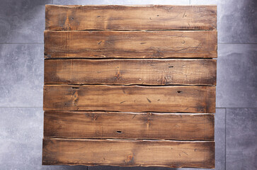 Wooden table top background at floor texture.  Brown wood board tabletop