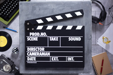 Movie clapboard or  clapper at old table. Clapperboard and screenwriter or movie writer concept