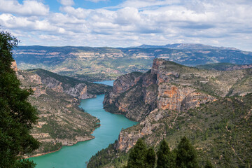 Natural environment of Cortes de pallás, in Valencia (Spain), with views of its mountains, the reservoir, Chirel Castle and its coniferous forests. On a sunny and cloudy day.