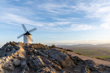 a whitewashed windmill in La Mancha in warm evening light