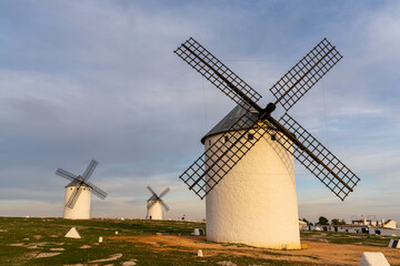 Fototapeta na wymiar the historic white windmills of La Mancha above the town of Campo de Criptana in warm evening light