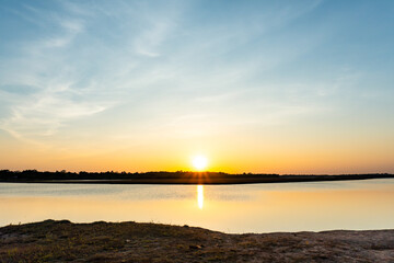 Sunset in the lake, beautiful sunset above the sea landscape background