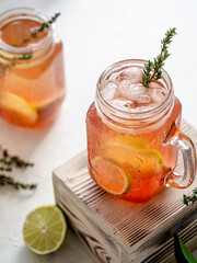 Cold tea with ice, lime in glass glasses. Refreshing beverage, summer mood.