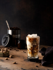 Cold coffee with cream on a dark background