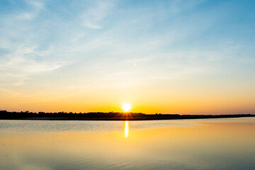 Naklejka na ściany i meble Sunset in the lake, beautiful sunset above the sea landscape background