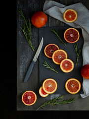 Discovered red oranges on a dark background top view