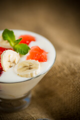homemade sweet yogurt with bananas and pieces of fruit jelly
