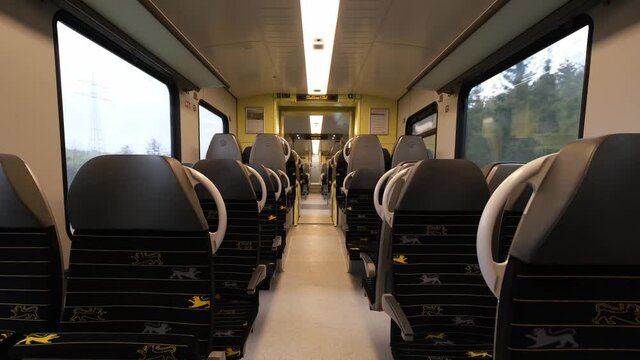 Regional DB passenger train without people due to the Covid-19 lockdown. Empty train in motion. Yellow Frankenbahn train on the way between W&uuml;rzburg and Stuttgart. Travel, public transport concept.